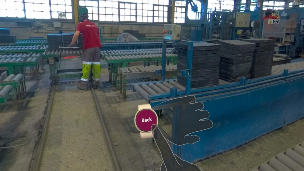 ista en realidad virtual de la línea de producción de pizarra de Cupa Pizarras con un operario y pilas de piezas